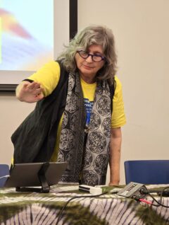 An image of Sherrie Tucker using the AUMI system.