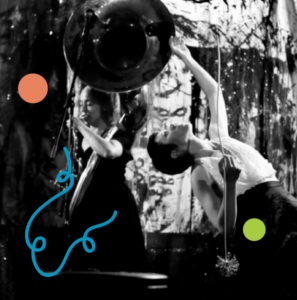 A photo of Yesenia Fuentes dancing, bending backwards with one arm stretched up into the air above her. In the background, Julie Richard plays a sousaphone. Image has been filtered in greyscale with colourful dots and a squiggly line added.